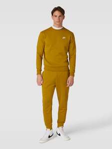 Spodnie dresowe z elastycznym ściągaczem - ciemnożółty Nike